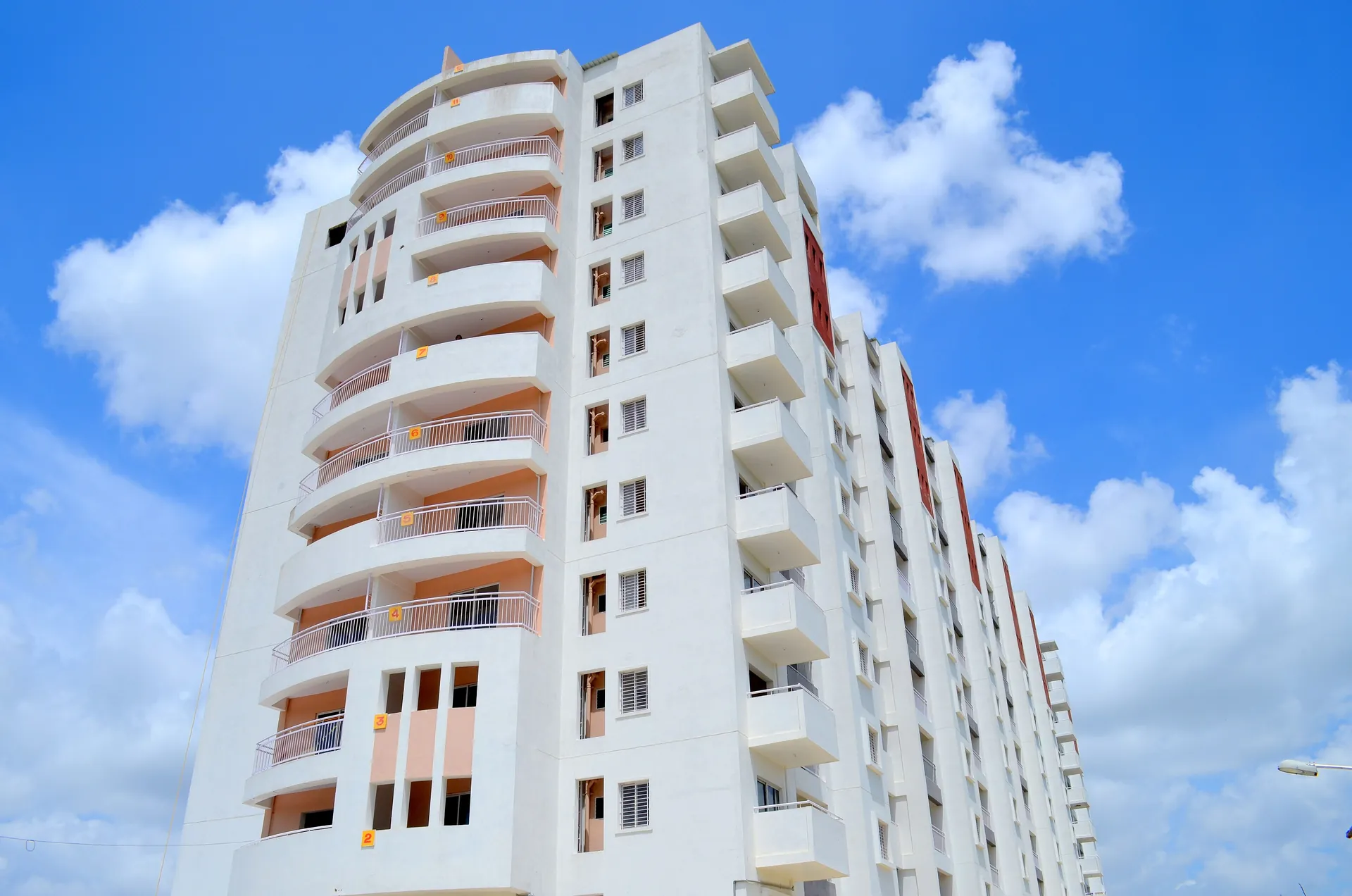 High-rise residential apartment tower in Bengaluru against a clear sky